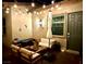 Outdoor living space featuring comfortable seating, string lights, and a stylish umbrella at 704 Webber Park St, Henderson, NV 89011