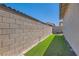 Neat backyard with artificial turf and a modern privacy wall, plus a hot tub at 704 Webber Park St, Henderson, NV 89011