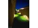 Cozy backyard featuring lush artificial grass and ambient lighting for evening enjoyment at 704 Webber Park St, Henderson, NV 89011