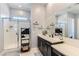 A stylish bathroom with a glass-enclosed shower and sleek vanity with a large mirror at 704 Webber Park St, Henderson, NV 89011