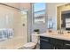 Modern bathroom with a glass-enclosed shower and vanity with dark cabinets at 704 Webber Park St, Henderson, NV 89011