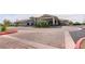 Well-maintained clubhouse exterior featuring manicured landscaping and a circular driveway at 704 Webber Park St, Henderson, NV 89011
