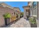 Well-maintained courtyard featuring pavers, potted plants, and a wooden bench at 704 Webber Park St, Henderson, NV 89011