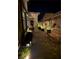 Evening courtyard with pavers, a wooden bench and potted plants at 704 Webber Park St, Henderson, NV 89011