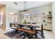A dining room table set for four, and a sliding glass door that leads to an outdoor patio at 704 Webber Park St, Henderson, NV 89011