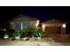 Inviting home exterior showcasing manicured landscaping and a paved driveway leading to the garage at 704 Webber Park St, Henderson, NV 89011