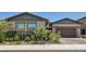 Charming single-story home boasts well-maintained landscaping, complemented by a paved driveway leading to an attached garage at 704 Webber Park St, Henderson, NV 89011
