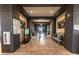 Inviting hallway featuring wood floors, decorative mirrors, and a comfortable seating area at 704 Webber Park St, Henderson, NV 89011