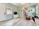 A well lit living room with grey wood floors, a TV, and contemporary furniture at 704 Webber Park St, Henderson, NV 89011
