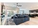 Open-concept living room featuring a large sectional sofa, seamless flow to the kitchen, and bright, airy atmosphere at 704 Webber Park St, Henderson, NV 89011