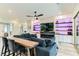 Stylish living room with a modern fireplace, custom built-in shelving, a comfortable sectional sofa, and a dining area at 704 Webber Park St, Henderson, NV 89011