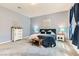 A main bedroom with carpet, a queen-sized bed, bedside tables and lamps, and a large window at 704 Webber Park St, Henderson, NV 89011