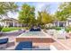 Charming outdoor lounge featuring a fire pit, seating and mature landscaping at 704 Webber Park St, Henderson, NV 89011