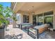 A relaxing covered patio with comfortable seating and well-maintained landscaping at 704 Webber Park St, Henderson, NV 89011