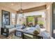 Covered patio area with comfortable seating, an overhead light fixture, and potted plants at 704 Webber Park St, Henderson, NV 89011