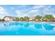 A gorgeous pool reflects the club house and blue sky in this beautiful community at 704 Webber Park St, Henderson, NV 89011