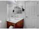 Bright bathroom featuring a single sink with vanity and a large mirror at 7120 Bear Paw Creek St # 101, Las Vegas, NV 89149