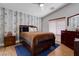 Comfortable bedroom with ceiling fan, accent wall, and natural light at 7120 Bear Paw Creek St # 101, Las Vegas, NV 89149