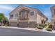 A townhome featuring desert landscaping and a multi-car garage in a well-maintained community at 7120 Bear Paw Creek St # 101, Las Vegas, NV 89149