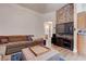 Comfortable living room featuring a large couch, modern decor, and access to other areas of the home at 7120 Bear Paw Creek St # 101, Las Vegas, NV 89149