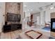 An open concept living area featuring a view of the kitchen, dining area, and fireplace at 7120 Bear Paw Creek St # 101, Las Vegas, NV 89149