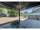 Backyard featuring a covered patio with a fire pit, a muraled wall, and a pool in view at 7137 Eyebright St, Las Vegas, NV 89131