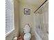 Bathroom features a tub/shower combo, tile floors, and natural light from a window at 7137 Eyebright St, Las Vegas, NV 89131