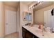 Bright bathroom featuring dual sinks, vanity storage, and modern fixtures offers convenience at 7137 Eyebright St, Las Vegas, NV 89131
