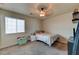 Bedroom with carpet features a window for natural light and a modern ceiling fan at 7137 Eyebright St, Las Vegas, NV 89131