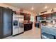 Spacious kitchen with a stainless steel refrigerator, dark cabinetry, and tile flooring at 7137 Eyebright St, Las Vegas, NV 89131