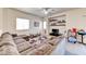 Bright living room with a large sectional sofa, ceiling fan, and open layout at 7137 Eyebright St, Las Vegas, NV 89131