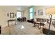 Bright and airy living room, featuring high ceilings, a large window, a comfortable sofa, and open access to the dining area at 7137 Eyebright St, Las Vegas, NV 89131