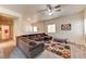 Spacious living room featuring a comfortable sectional, ceiling fan, and ample natural light at 7137 Eyebright St, Las Vegas, NV 89131