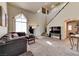 Inviting living room with high ceilings, large windows, a comfortable sectional sofa, and carpet, perfect for relaxing and entertaining at 7137 Eyebright St, Las Vegas, NV 89131