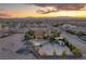 Desert home at sunset with horse property, white fencing, lush trees and mountain views at 743 N Orleans St, Henderson, NV 89015