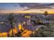 Aerial view of home at sunset featuring city views, lush landscaping and mature palm trees at 743 N Orleans St, Henderson, NV 89015