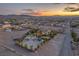 Desert home at sunset with horse property, white fencing, lush trees and mountain views at 743 N Orleans St, Henderson, NV 89015