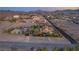 Expansive desert estate with tile roof, lush trees, wrought iron fence and beautiful landscaping at 743 N Orleans St, Henderson, NV 89015