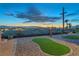 Backyard with gravel, synthetic turf, a water feature, and city views at sunset at 743 N Orleans St, Henderson, NV 89015