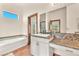 Bathroom featuring a large tub and vanity with granite counters at 743 N Orleans St, Henderson, NV 89015