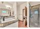 Bathroom featuring double sinks with marble countertops, and a glass-enclosed shower at 743 N Orleans St, Henderson, NV 89015