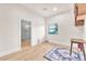 Bright bedroom featuring wood floors, neutral walls, and a bathroom with a glass shower at 743 N Orleans St, Henderson, NV 89015