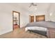 Bright bedroom with wood floors, a ceiling fan, and an ensuite bathroom at 743 N Orleans St, Henderson, NV 89015