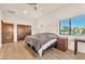 Bedroom with wood floors, neutral walls, ensuite bathroom, and a large window at 743 N Orleans St, Henderson, NV 89015