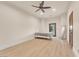 Bright bedroom featuring a ceiling fan, wood floors, door to the outside, and access to bathroom at 743 N Orleans St, Henderson, NV 89015