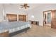Spacious bedroom with wood floors, a ceiling fan, and ensuite bathroom at 743 N Orleans St, Henderson, NV 89015