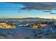 Las Vegas skyline view from backyard with desert landscaping, turf and hillside vantage point at 743 N Orleans St, Henderson, NV 89015