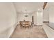 Elegant dining room with a large round table, chandelier, and custom cabinetry at 743 N Orleans St, Henderson, NV 89015