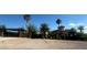 Long driveway and security gate with lush landscaping and mature trees at 743 N Orleans St, Henderson, NV 89015