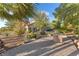 Landscaped backyard features an outdoor dining area, trees and other plantings at 743 N Orleans St, Henderson, NV 89015